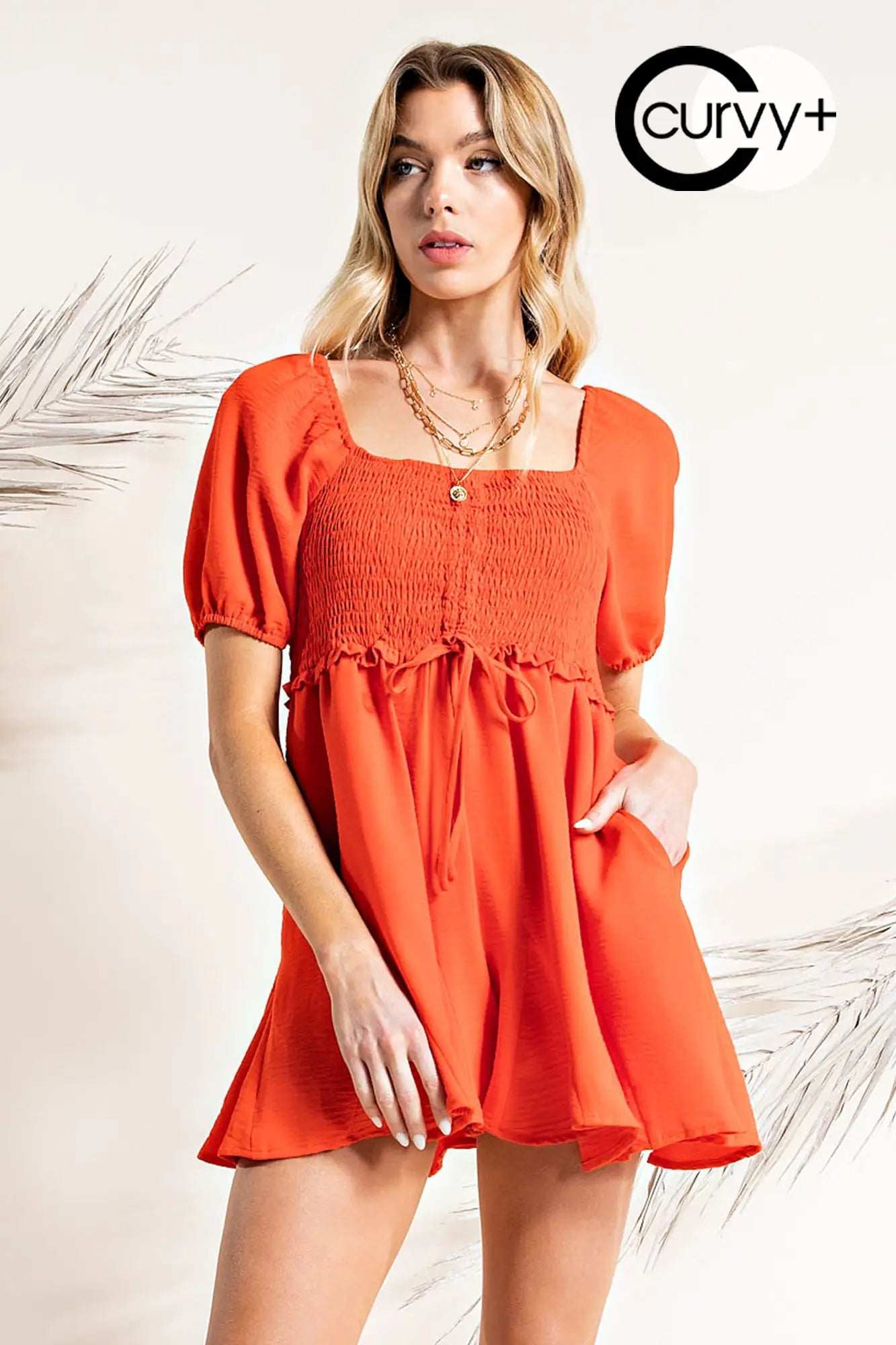 Plus size orange romper with flared detail. Perfect to wear in San Luis Obispo, CA.