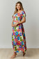 This abstract floral print maxi dress features a cut-out back with a square neckline and short puff sleeves.  The dress is composed with a smocked bodice.
