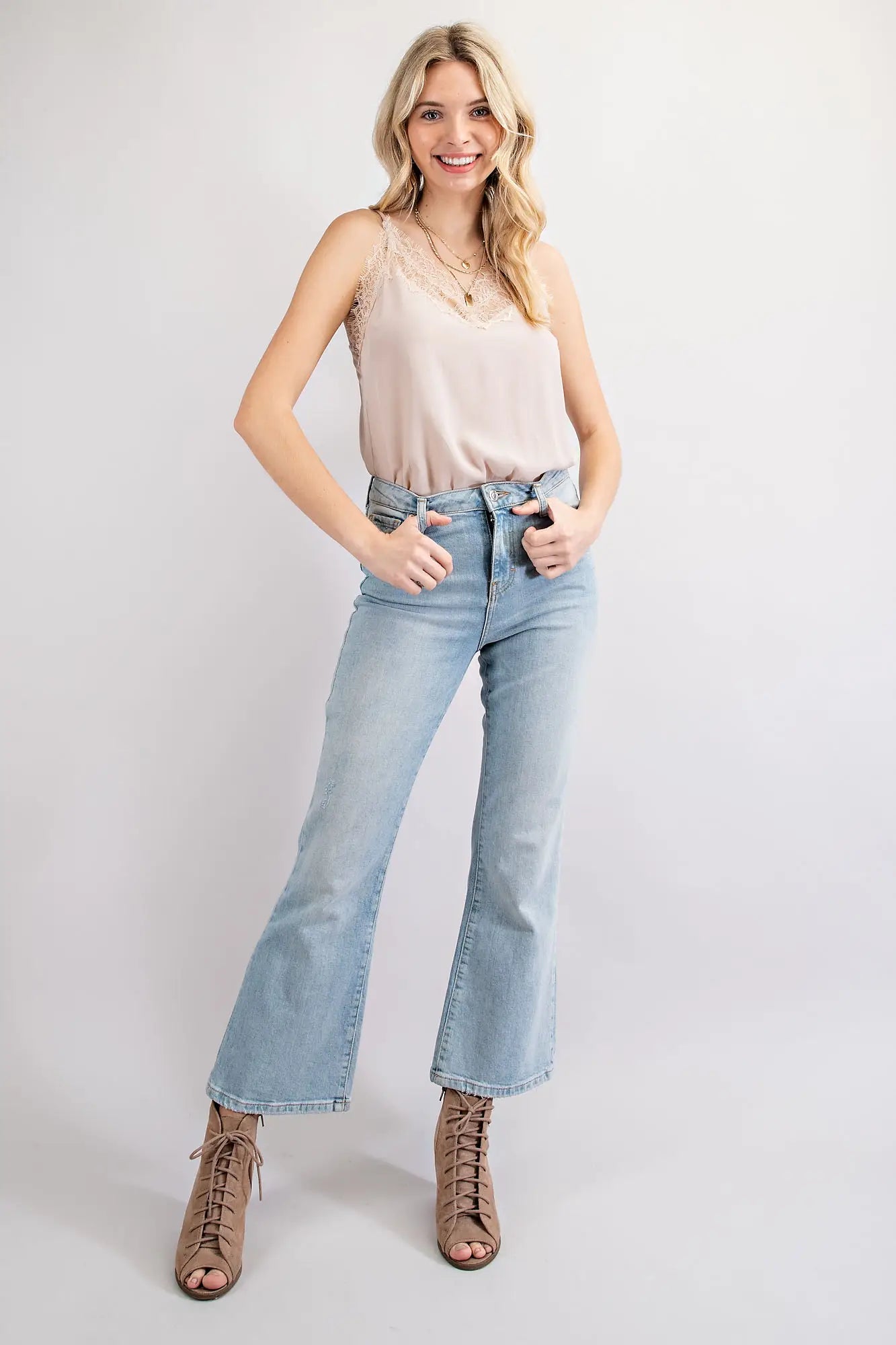 Girl wearing a Champagne colored bodysuit and jeans. This is perfect for the warm days in San Luis Obispo.