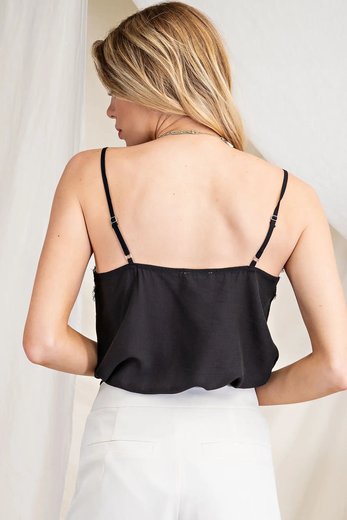 Girl wearing a Black lace colored bodysuit. This is a view from the back. This is perfect for the warm days in San Luis Obispo.