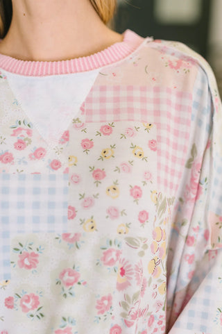 Close-up of a person wearing a floral-patterned outfit with a pink collar.