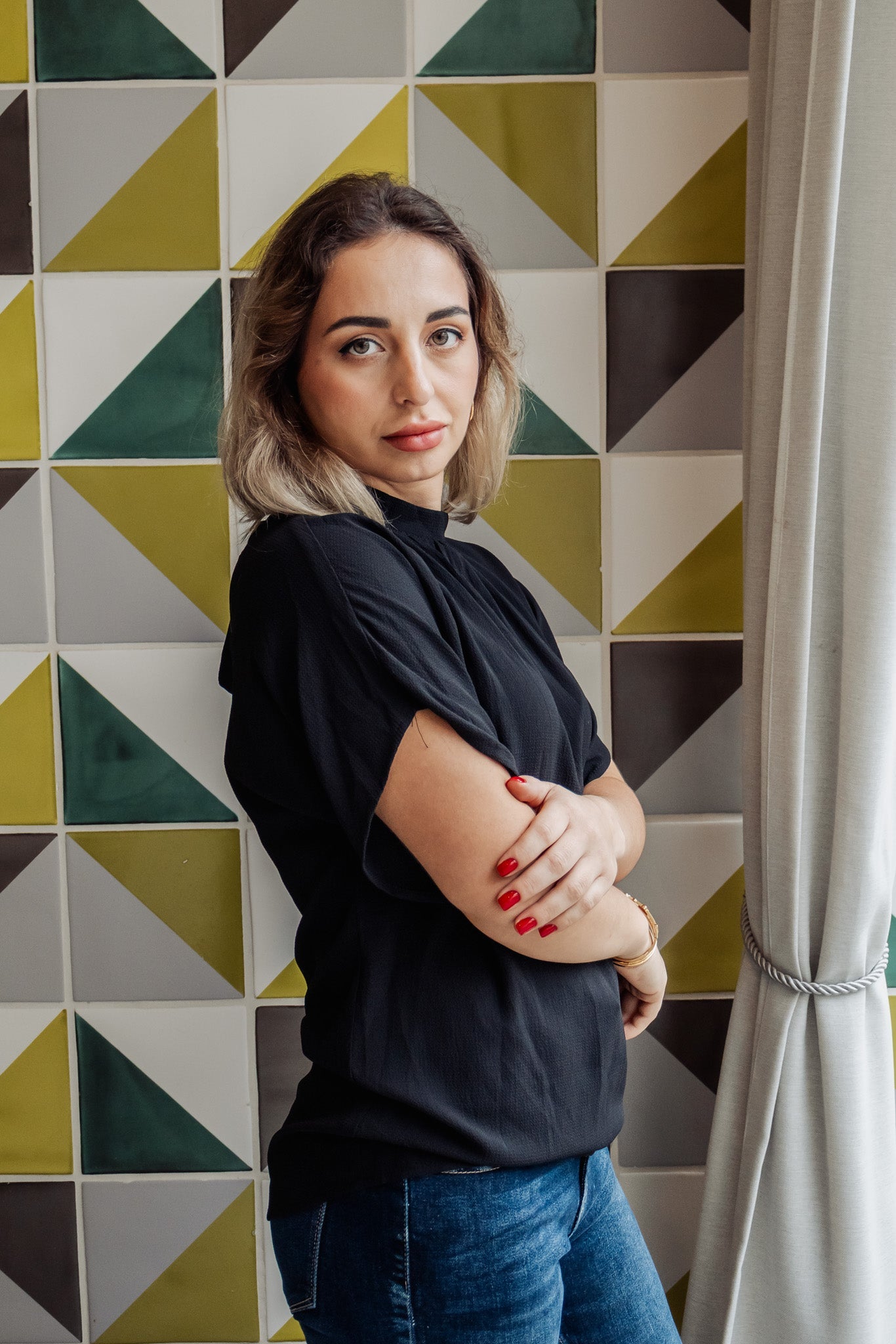 Woman standing in front of a geometric-patterned wall
