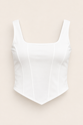 A white sleeveless cropped top with a square neckline and structured, corset-style front panels, shown flat against a light beige background.