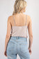 Girl wearing a Champagne colored bodysuit. She is shown from the back. This is perfect for the warm days in San Luis Obispo.
