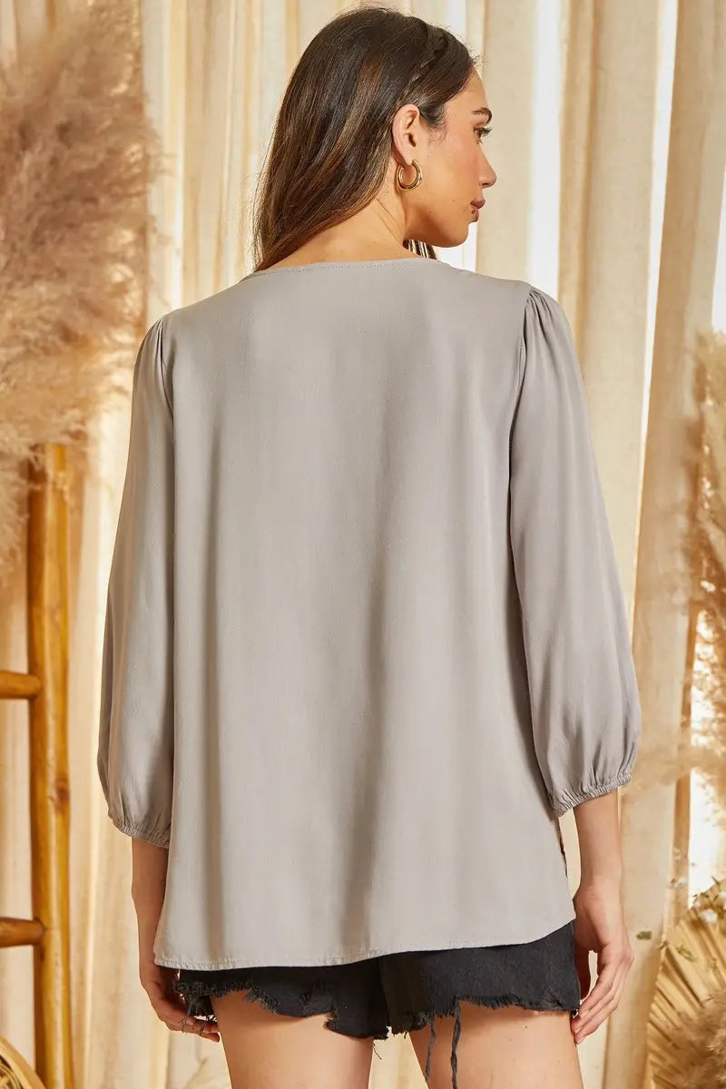 This blouse features v neckline, balloon sleeves, and scallop hemline. Non sheer, woven.