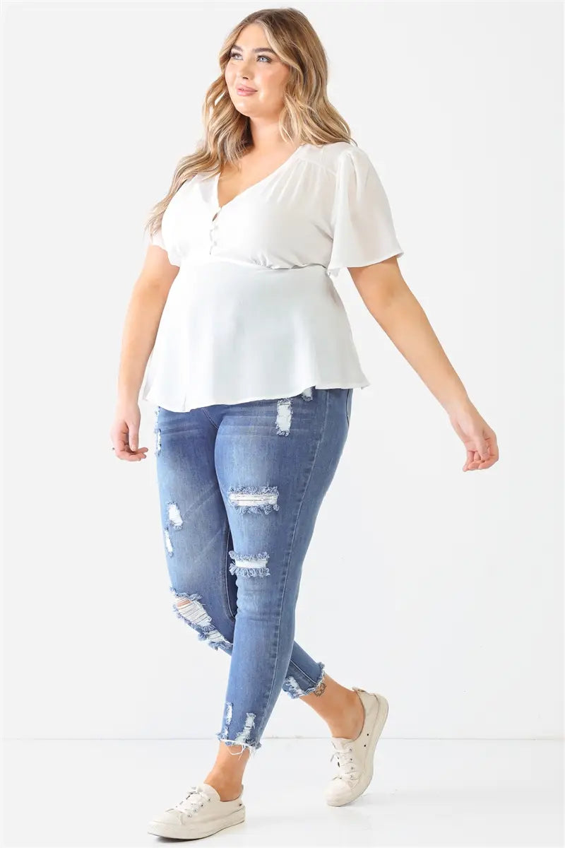 This top is crafted with a textured finish, a v-neckline with a button-up closure, short sleeves, and a self-tie detail for a flattering flared silhouette. The lightweight fabric has a slight stretch, is not see-through, and is unlined