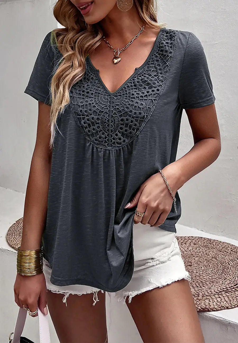 The Anna-Kaci shirt is detailed with a pretty lace detail. Features a v neck line, short sleeves, rounded hem, and flowy fit. 