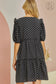 dress features a polka dot print and puff sleeves with ruffle accents. It has a tiered bodice and a v-neckline, and is constructed in a babydoll silhouette. 