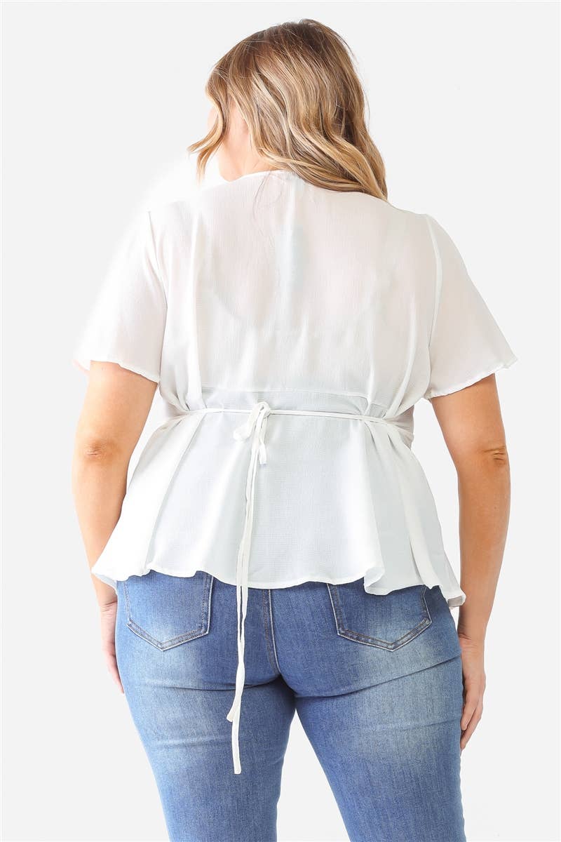 This top is crafted with a textured finish, a v-neckline with a button-up closure, short sleeves, and a self-tie detail for a flattering flared silhouette. The lightweight fabric has a slight stretch, is not see-through, and is unlined