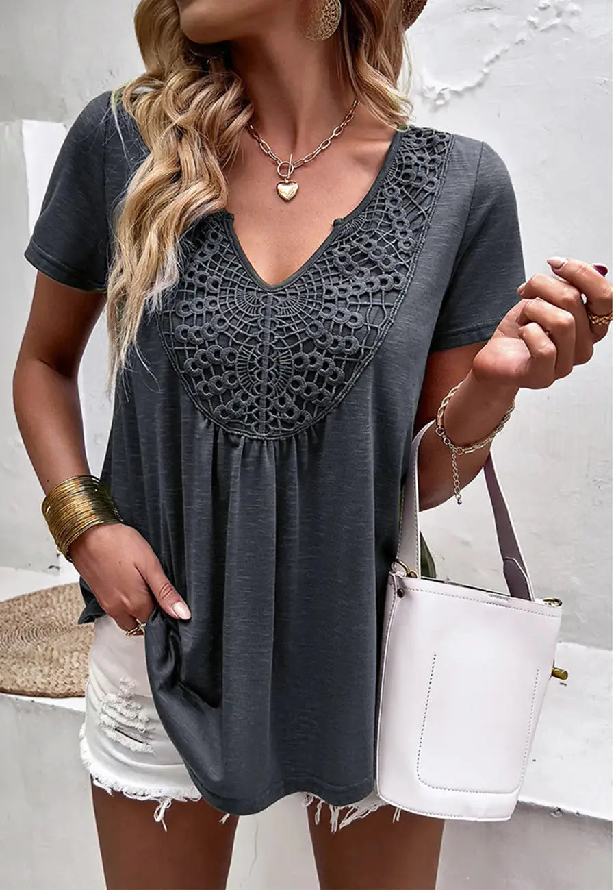 The Anna-Kaci shirt is detailed with a pretty lace detail. Features a v neck line, short sleeves, rounded hem, and flowy fit. 