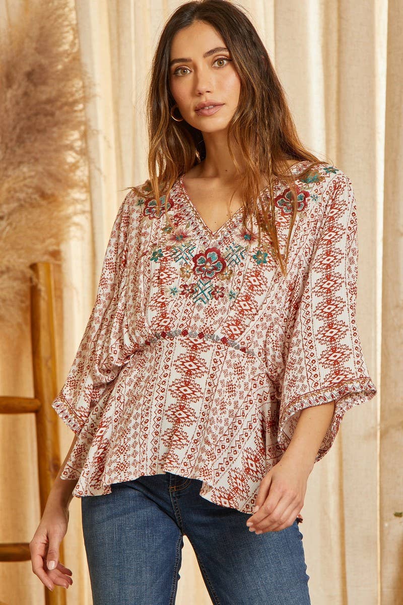  Poncho like woven top with embroidery detail on front. This top features v neckline with pleat details on the waist to give you the best shape ever!