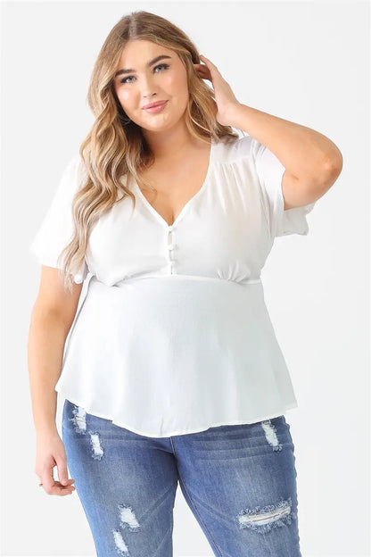 This top is crafted with a textured finish, a v-neckline with a button-up closure, short sleeves, and a self-tie detail for a flattering flared silhouette. The lightweight fabric has a slight stretch, is not see-through, and is unlined.