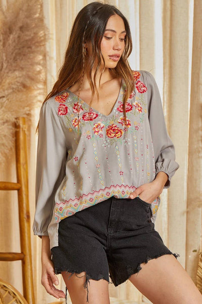 This blouse features v neckline, balloon sleeves, and scallop hemline. Non sheer, woven.
